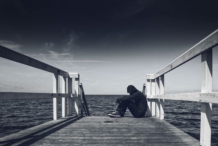 Slippery slopes - man sitting on pier - black and white pier - great oaks recovery