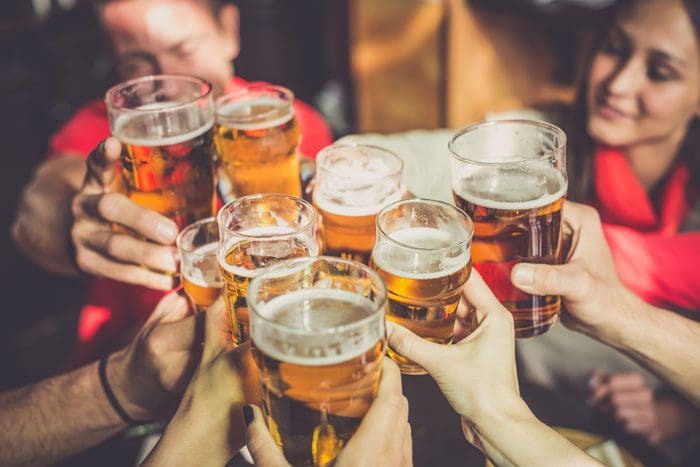 Alcohol-and-the-College-Years-Part-two - several beer glasses being held up for cheers