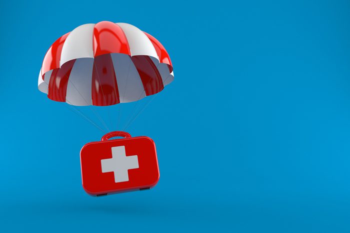 How Does Naloxone Work to Stop an Overdose - first aid kit parachute on blue background