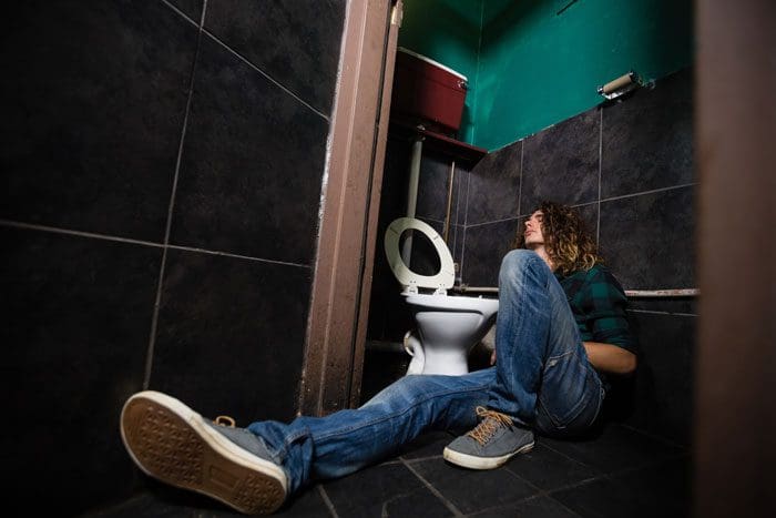 man on floor of bathroom