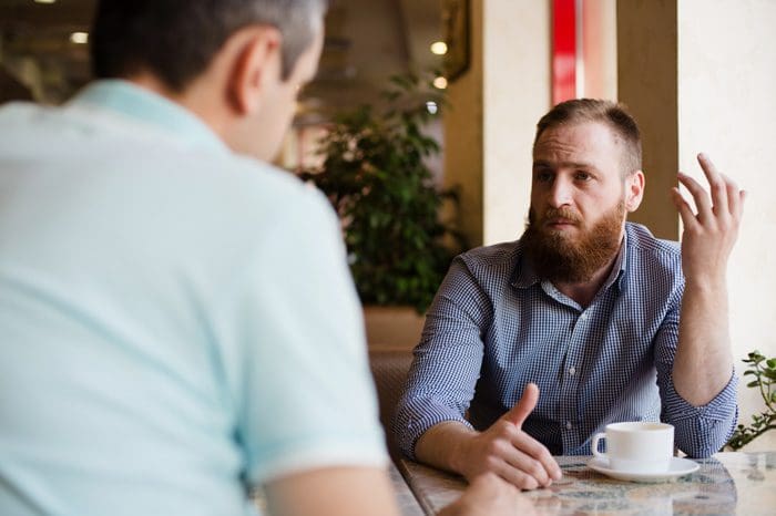 two men having serious discussion - words