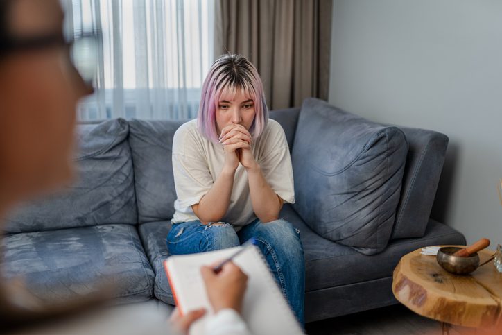 Hopeless Young woman talking with her Therapist