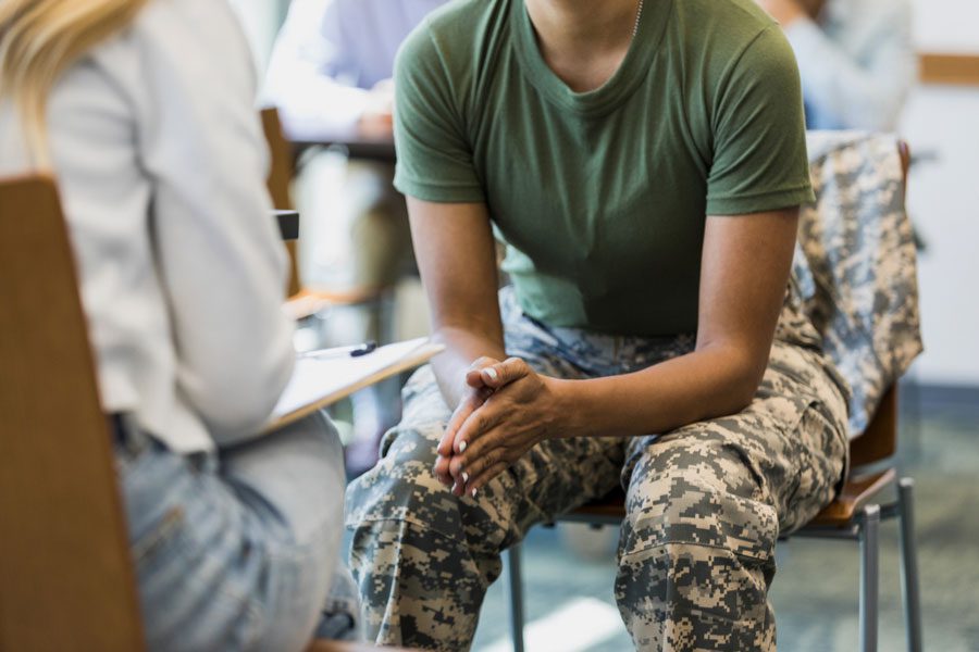 female soldier in military talking with a counselor