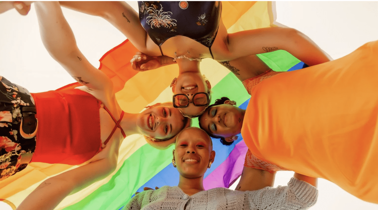 Teens with a pride flag.
